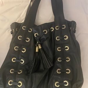 Michael Kors black leather tote with gold grommets . Great condition